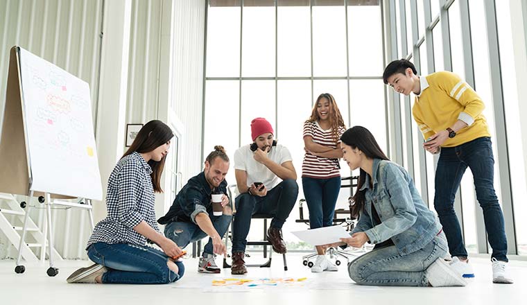 A photo of a creative team at work and laughing together