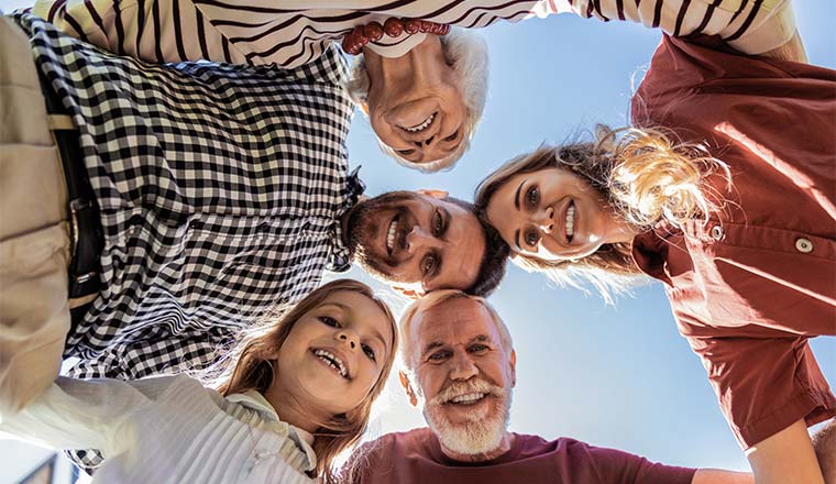 A photo of a huddle between people of different generations