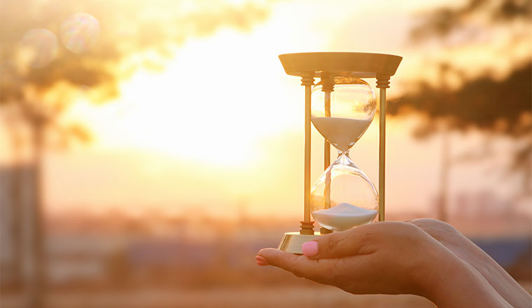 A photo of someone holding a sand timer