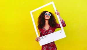 A photo of a woman taking a picture of herself for social media