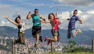 A photo of four people happily jumping