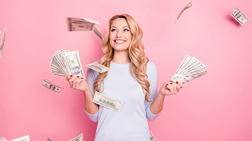 A photo of a woman standing under a shower of money