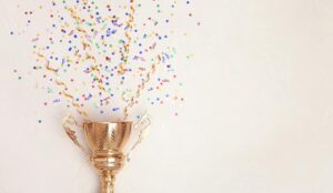 A photo of a trophy with confetti coming from the top