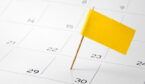 A yellow flag is placed on a calendar