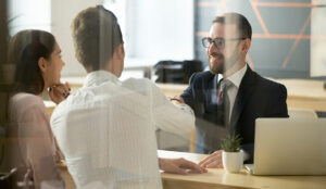 A man in a suit shakes hand with a customer