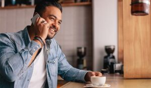 A photo of a man smiling on his phone