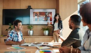 A photo of someone making a presentation on a wallboard