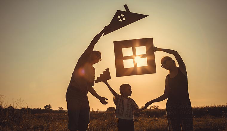 A family play with cardboard cut-outs