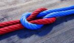 A red and a blue rope are tied togetherin a reef not