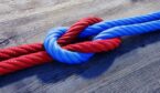 A red and a blue rope are tied togetherin a reef not