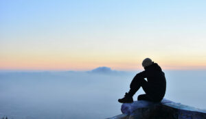 A photo of someone in consideration while looking across mountain range