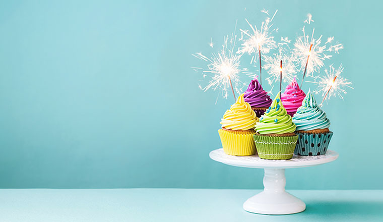 A photo of five cupcakes on a stand