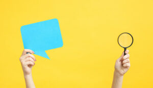 A photo of a speech bubble and a magnifying glass