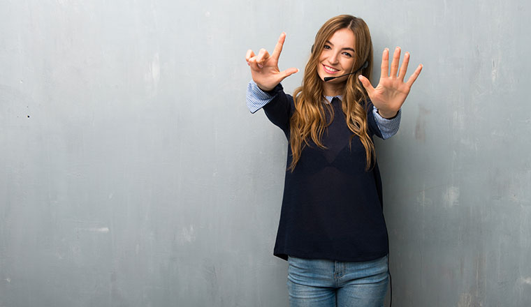 A photo of call centre advisor holding out seven fingers