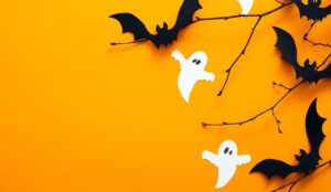 A photo of ghosts and bats, and sticks on an orange background