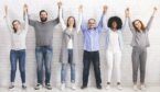 A photo of a group of people holding their hands in the air