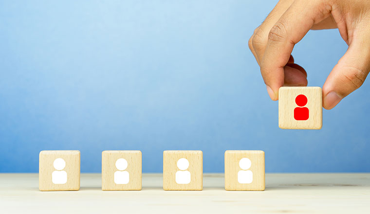 A picture of a hand moving blocks with people on them