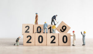 Little workman figures on top of 2020 building blocks