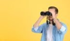 A photo of someone holding binoculars infront of their face