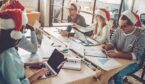 A picture of office workers wearing Christmas hats