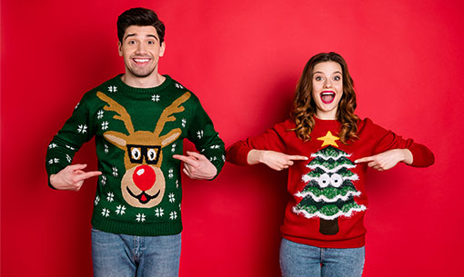 A photo of people wearing ugly Christmas jumper