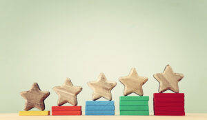 A picture of 5 wooden stars on wooden blocks that increase in height from 1 to 5
