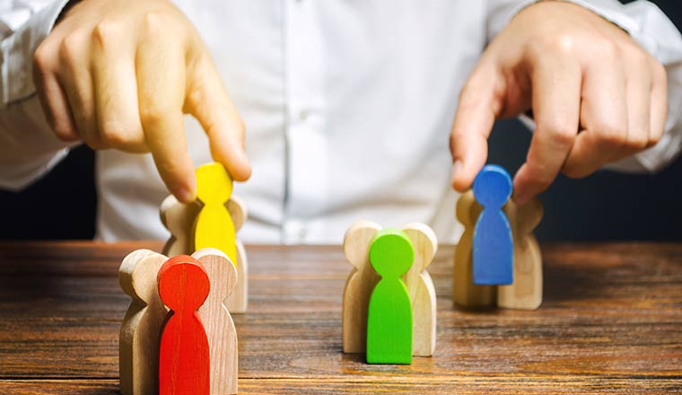 A picture of wooden people figures grouped together