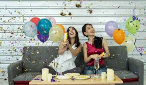 A picture of two females celebrating at a party