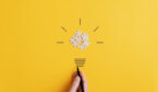 A photo of a light bulb made from puzzel pieces