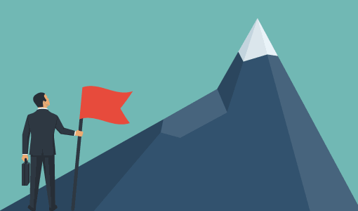 A picture of a person with a flag looking up at a mountain