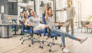 A photo of people playing office chair conga