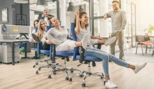 A photo of people playing office chair conga