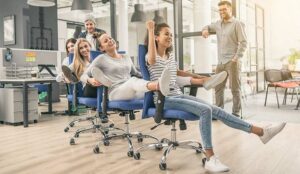 A photo of people playing office chair conga