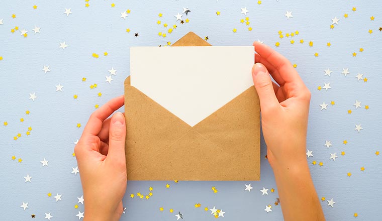 A photo of an envelope being opened with confetti