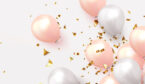 A pictiure of pink and white balloons, with golden confetti