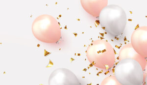 A pictiure of pink and white balloons, with golden confetti