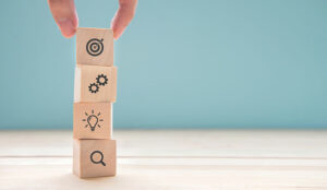 A photo of blocks being stacked with strategy symbols