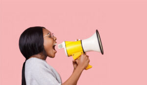 A picture of a person shouting down a microphone