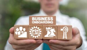 A picture of a person holding blocks that depict an onboarding process