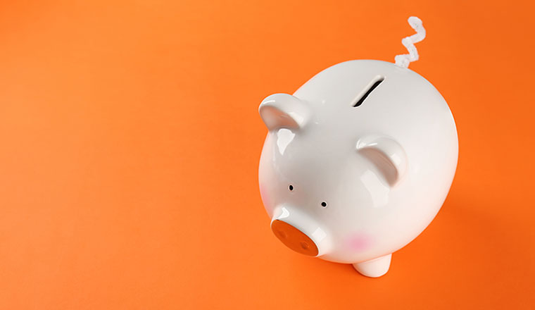 A picture of a piggy bank on an orange background