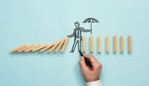 A picture of someone holding an umbrella over wooden blocks