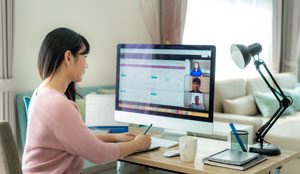 A woman is on a video call, working from home