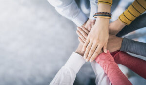 A picture of of a group of hands joining together