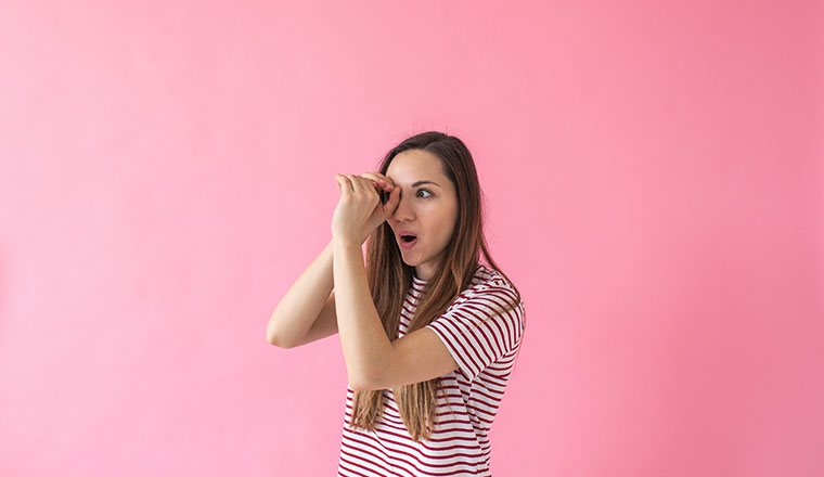 A photo of some looking through a "hand telescope"