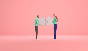 A photo of two people connecting puzzle pieces