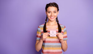 A photo of someone holding a smiley face post-it