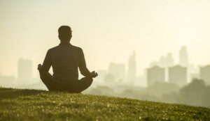 A picture of someone meditating outside