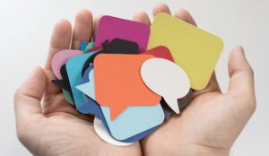 A photo of multi-colour speech bubbles in hands