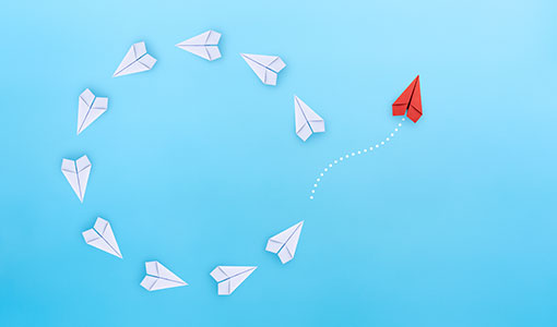 A picture of paper planes circling indicating change