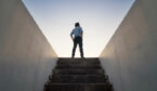 A picture of someone climbing stairs to the future
